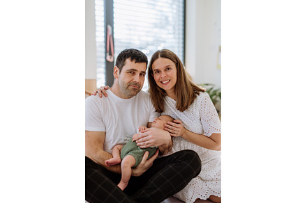 Happy parents cuddling with their, a Person Photo by HalfPoint