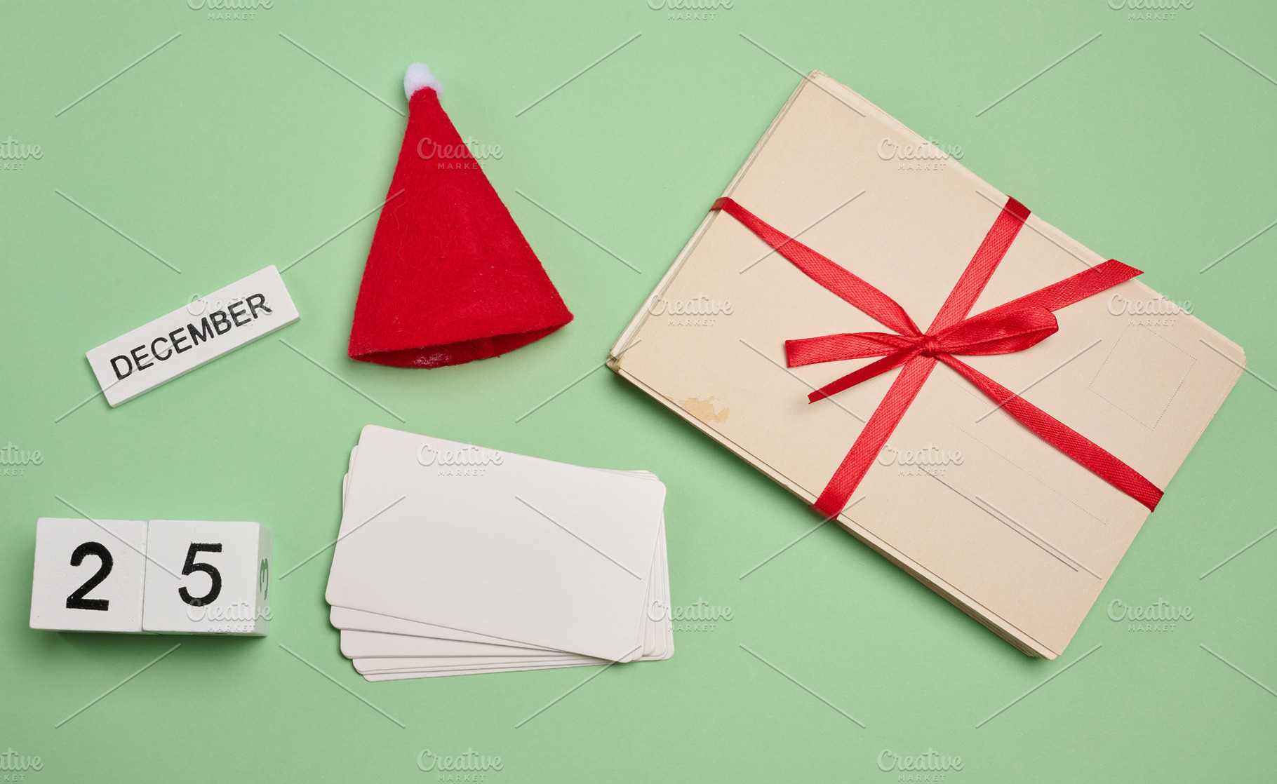Set of Christmas elements: red Santa hat, cards, blank cards and, a Holiday Photo by ndanko