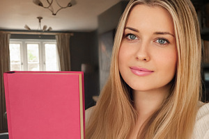 Young woman with blonde hair and blue eyes presenting a vibrant, a Person Photo by Studio ANNA
