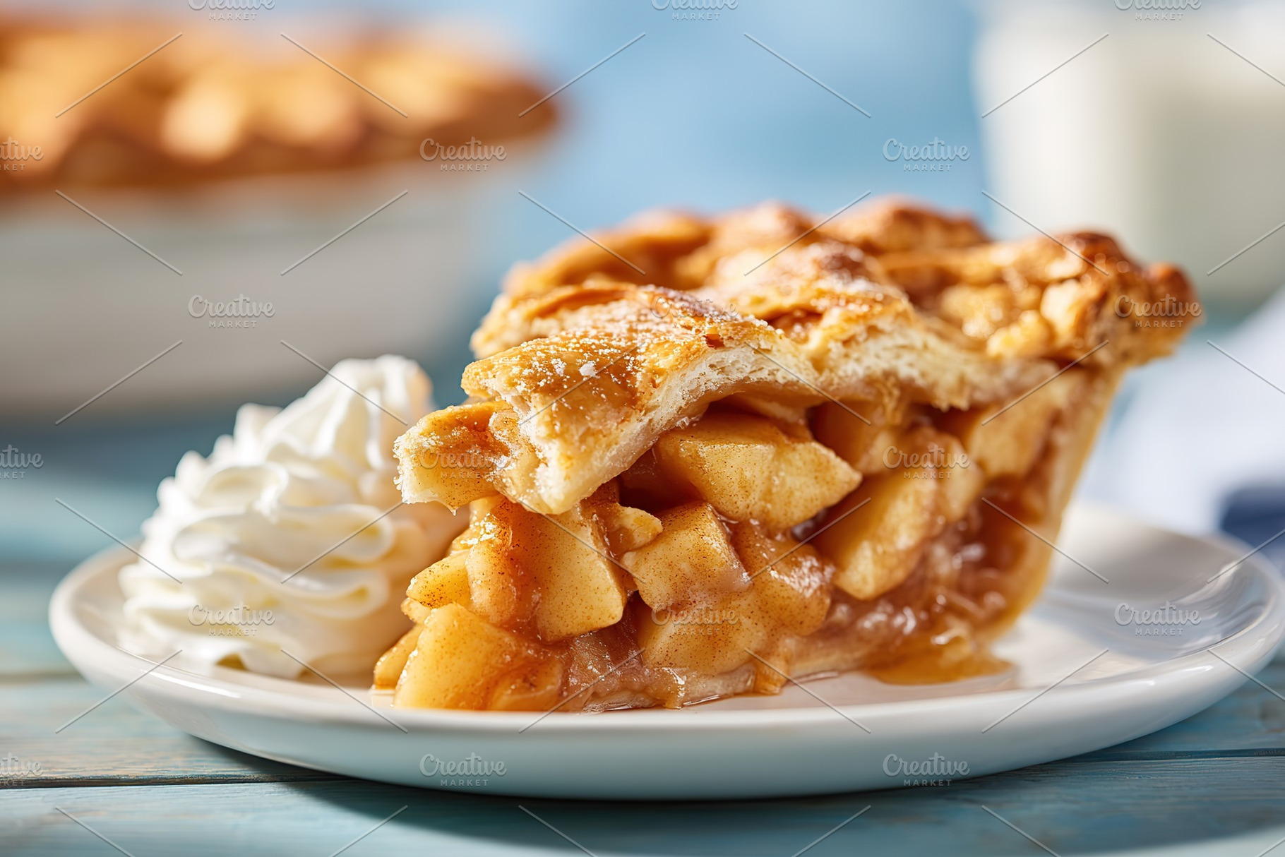Delicious apple pie slice with whipped cream served on a white plate and blue w, a Food & Drink Photo by AlyaAnd