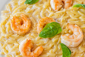Creamy orzotto pasta topped with gri, a Food & Drink Photo by Alexander Prokopenko