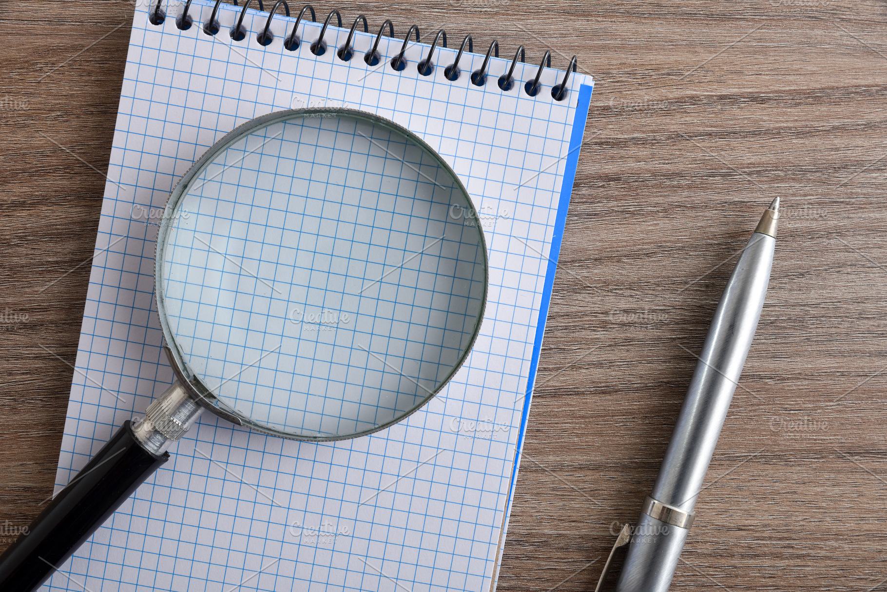 Magnifying Glass on Blank Notebook Page, a Business Photo by Davizro's Market