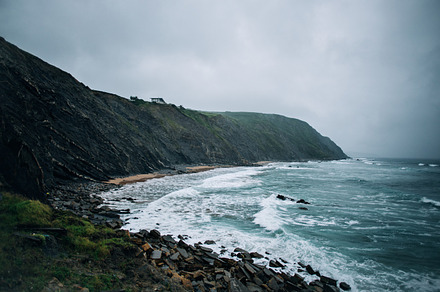 Moody rainy day on rocky beach, a Holiday Photo by DeRepente