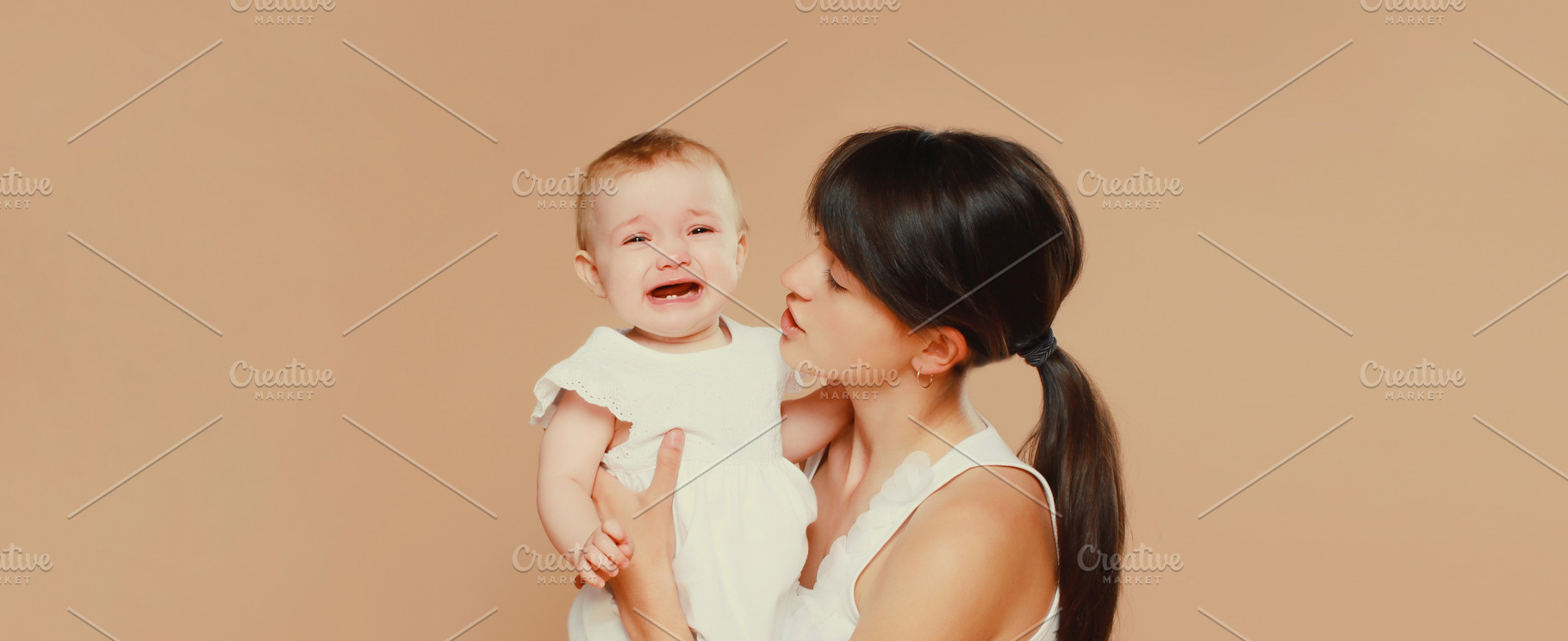 young mother holding crying baby on, a Person Photo by Rohappy