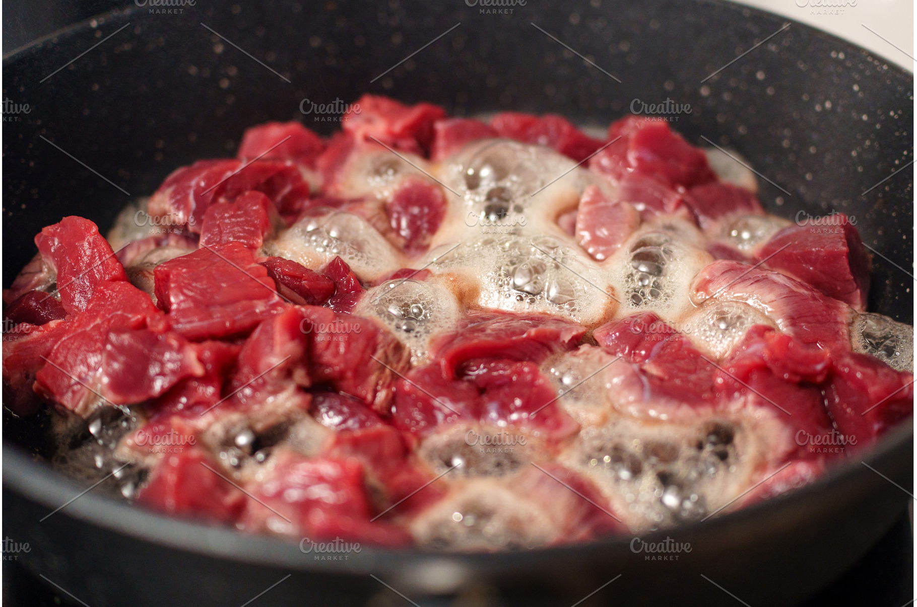 Chunks of raw beef are sizzling in a, a Food & Drink Photo by darksoul72