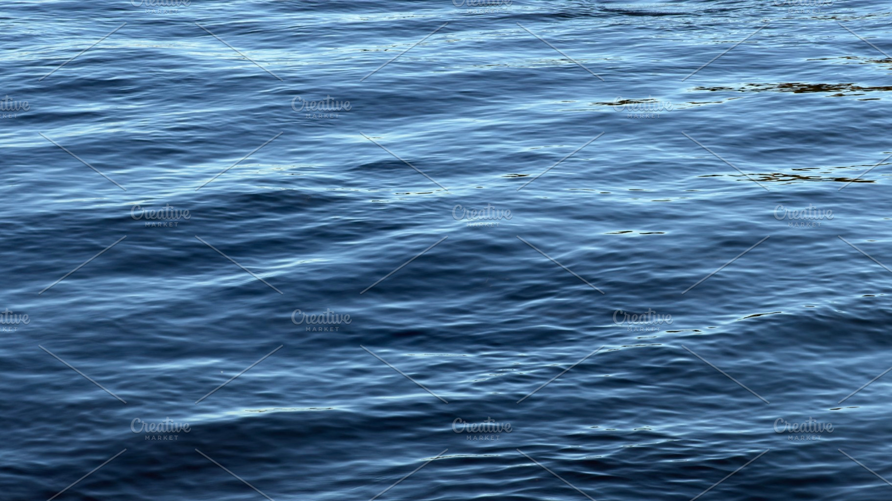 Calm blue water surface with gentle waves, a Nature Photo by Textures & Backgrounds