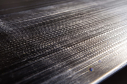 Detailed view of a brushed metal sur, a Photo by Iftikhar Alam