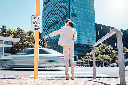 Woman, traffic light button and city road waiting to cross pedestrian to walk or commute to work office building. Female with covid mask at crosswalk by asphalt street while traveling in south africa, a Photo by Peopleimages.com