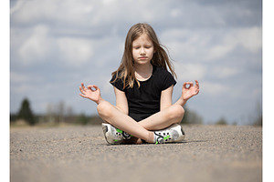 Girl in lotus position meditating on, a Person Photo by Nenahliadava Design