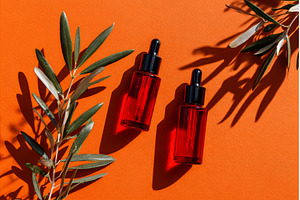 A red glass bottle with a silver lid, a Nature Photo by ZinetroN