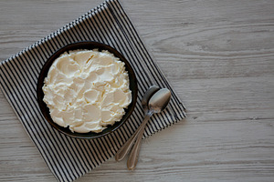 Organic White Mascarpone Cheese in a Bowl, top view. Copy space., a Food & Drink Photo by LiudmylaChuhunova