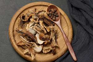Dried forest mushrooms in a wooden plate, a Food & Drink Photo by ndanko