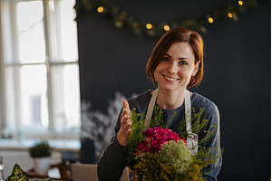 Smiling female florist working in, a Person Photo by HalfPoint