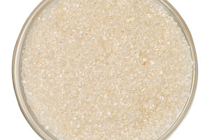 White cane sugar in a clear glass bowl, top view, isolate, a Food & Drink Photo by ndanko