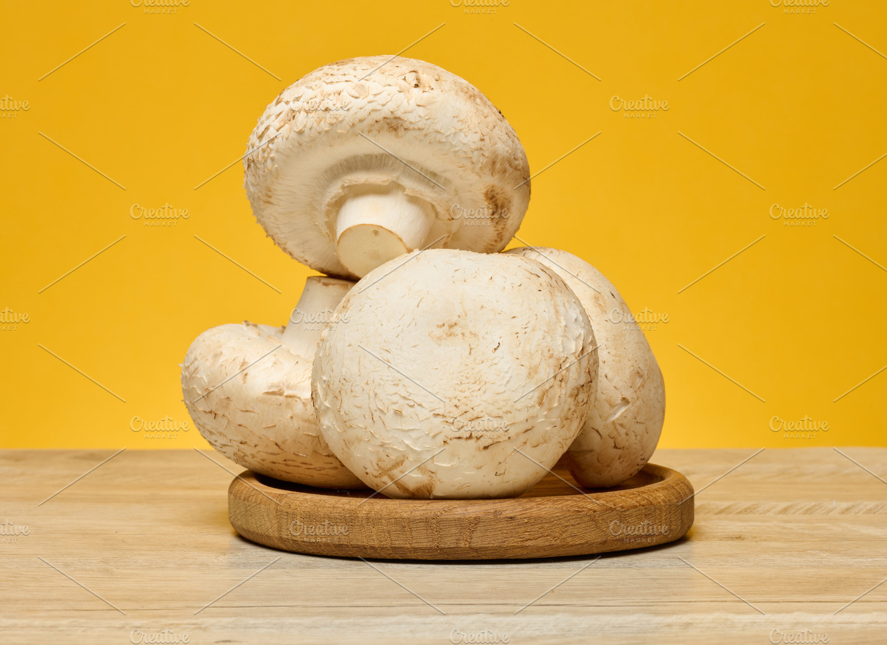 Fresh champignons with white caps and light brown stems, arrange, a Food & Drink Photo by ndanko