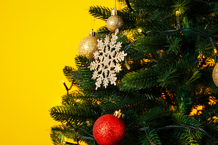 Christmas tree on yellow background, space for text, a Holiday Photo by AtlasStudio PRO