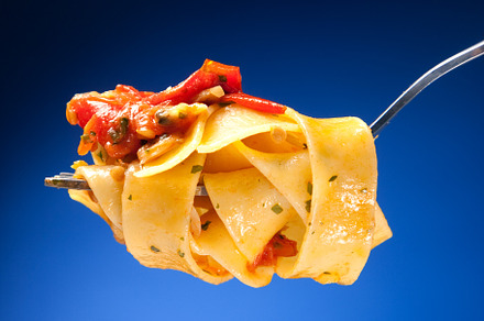 Tagliatelle with clams on a red background