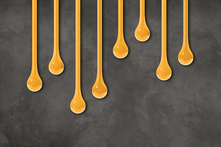 Yellow ink drops on dark concrete wall. Horizontal wallpaper, a Background Photo by GoodGoods