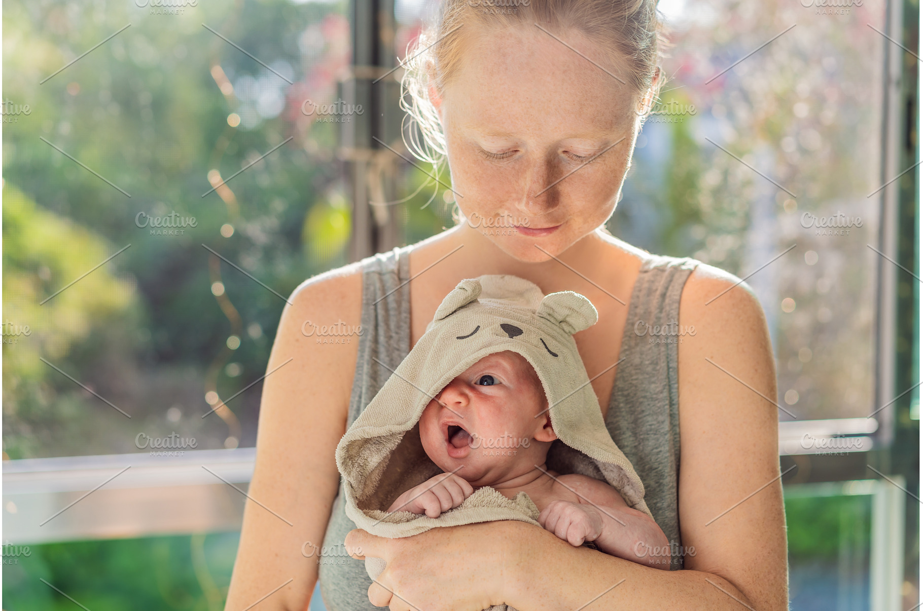 Mother holding her baby in a bath, a Person Photo by Elizaveta Galitskaya