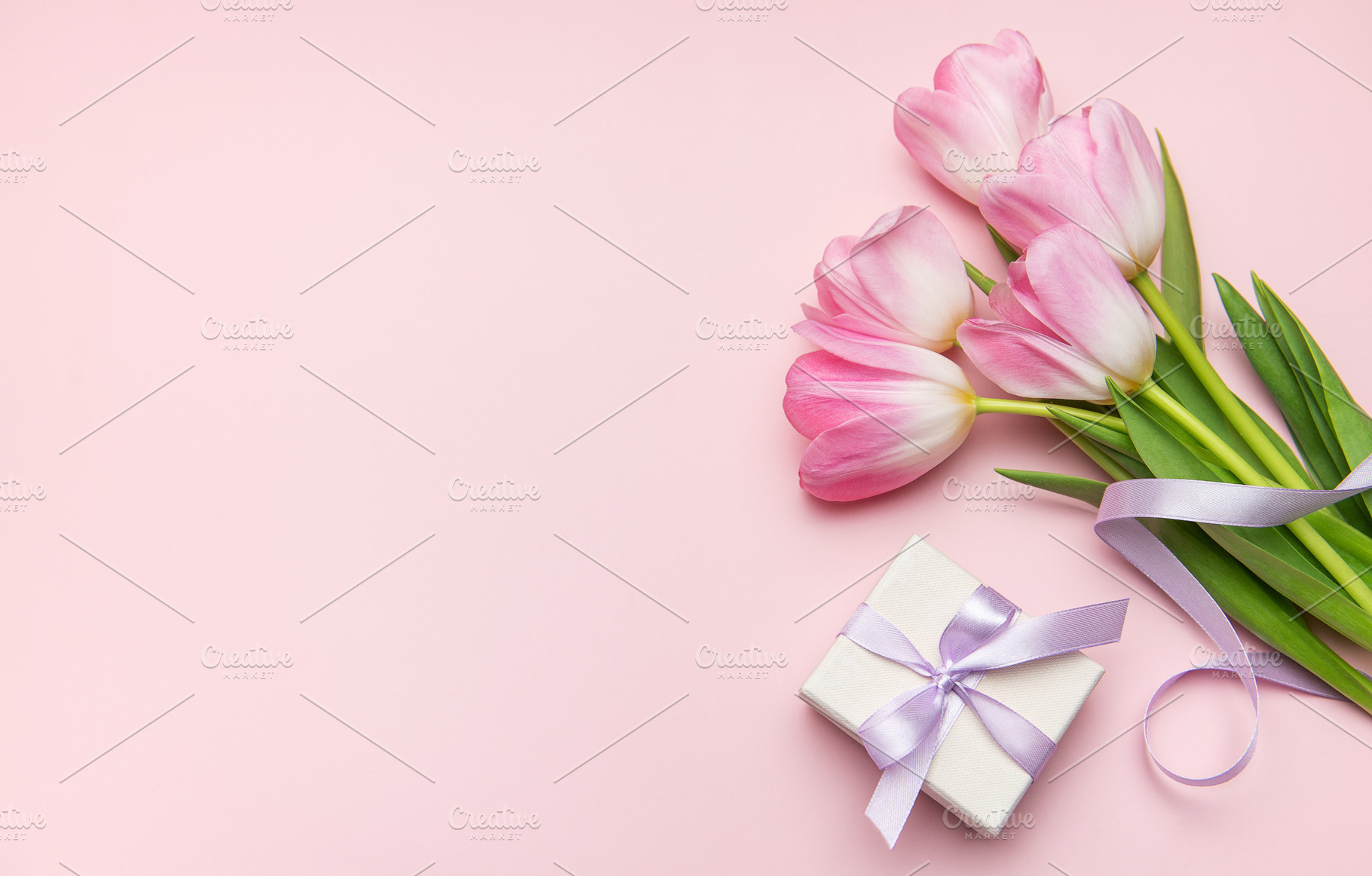 Pink tulips and gift box on pastel pink background for mother's, a Holiday Photo by Olena Rudo