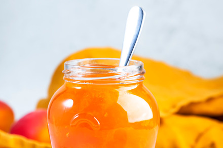 Orange Apricot jam or confiture in glass jar with spoon and fres, a Food & Drink Photo by 5PH
