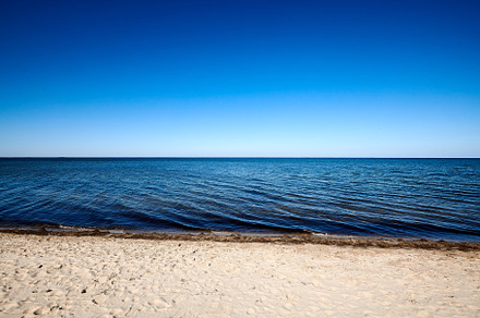 lonely beach with blue sky without clouds