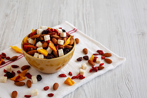 Healthy Dried Fruit and Nut Mix in a Bowl, side view. Space for, a Food & Drink Photo by LiudmylaChuhunova