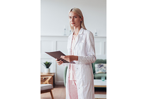 Portrait of female doctor in office, a Health & Medical Photo by undrey