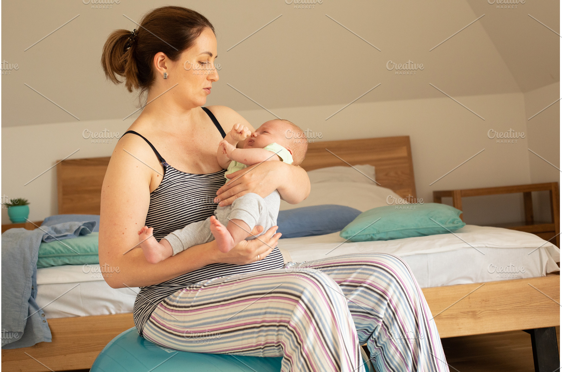 Mother holding and rocking baby, a Person Photo by oksix