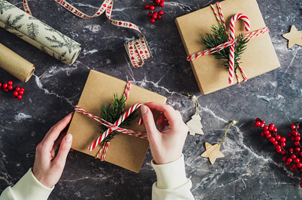 Christmas vintage gift box in female hands on stone table. Xmas or New Year pre, a Holiday Photo by photoguns