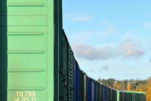 A row of green freight train cars on a railway track under a blue sky, an Industrial Photo by Textures & Backgrounds