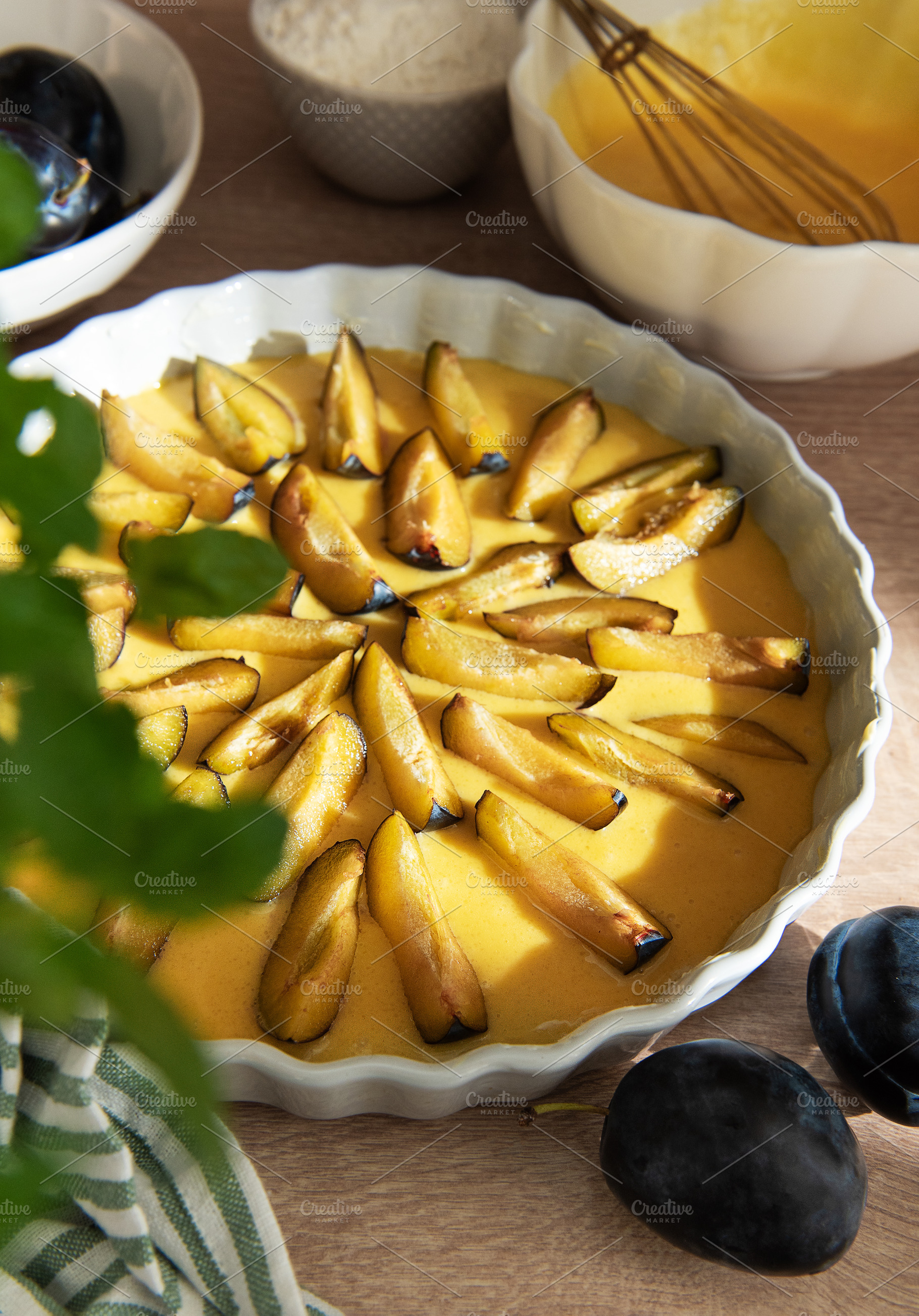 Preparing homemade plum tart for baking dessert, a Food & Drink Photo by Olena Rudo