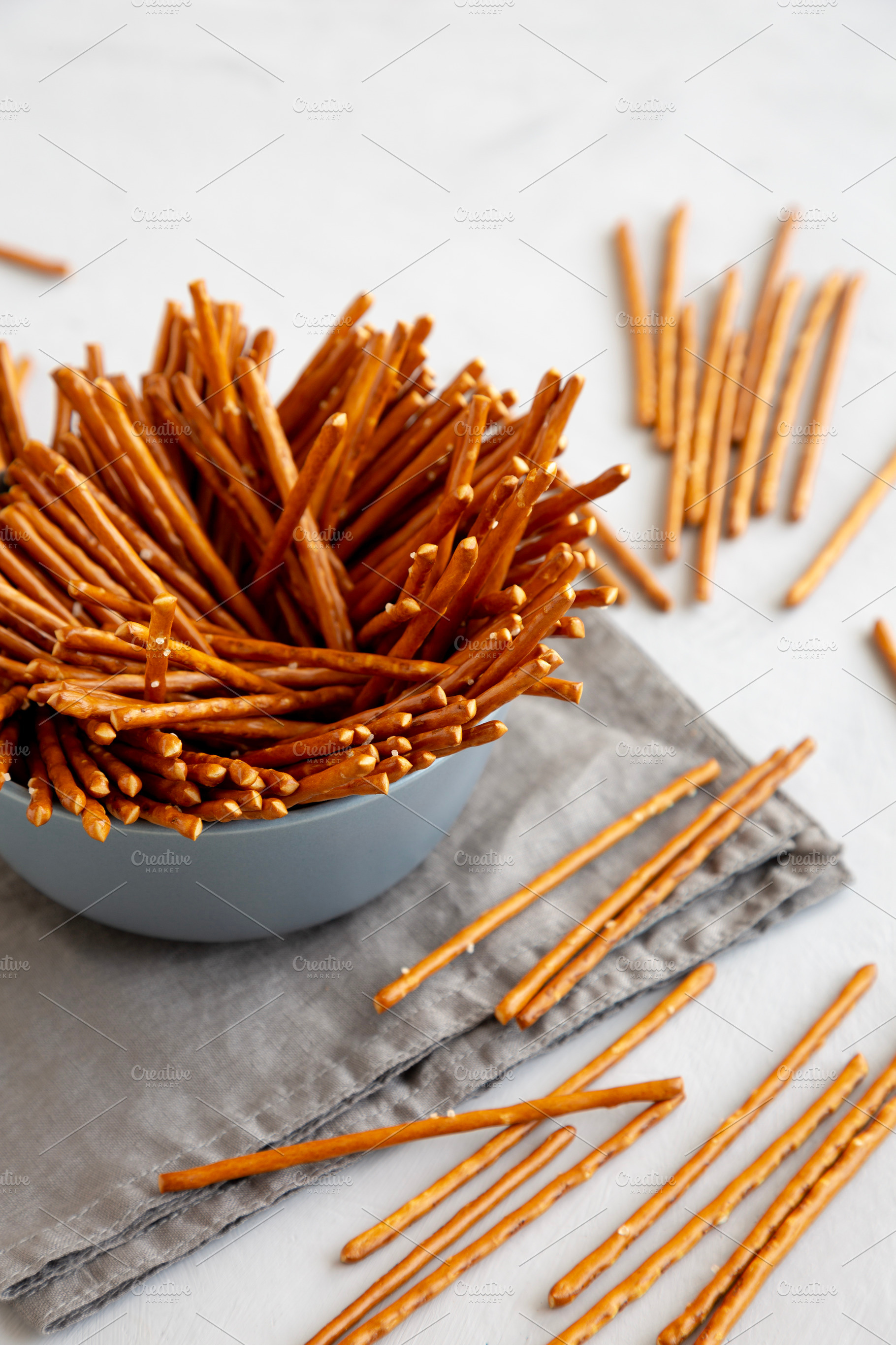 Organic Salty Pretzel Sticks in a Bowl, side view., a Food & Drink Photo by LiudmylaChuhunova