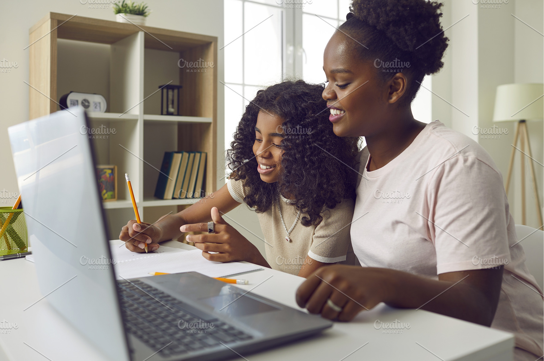 Happy young African American mother, a School & Education Photo by StudioRomantic