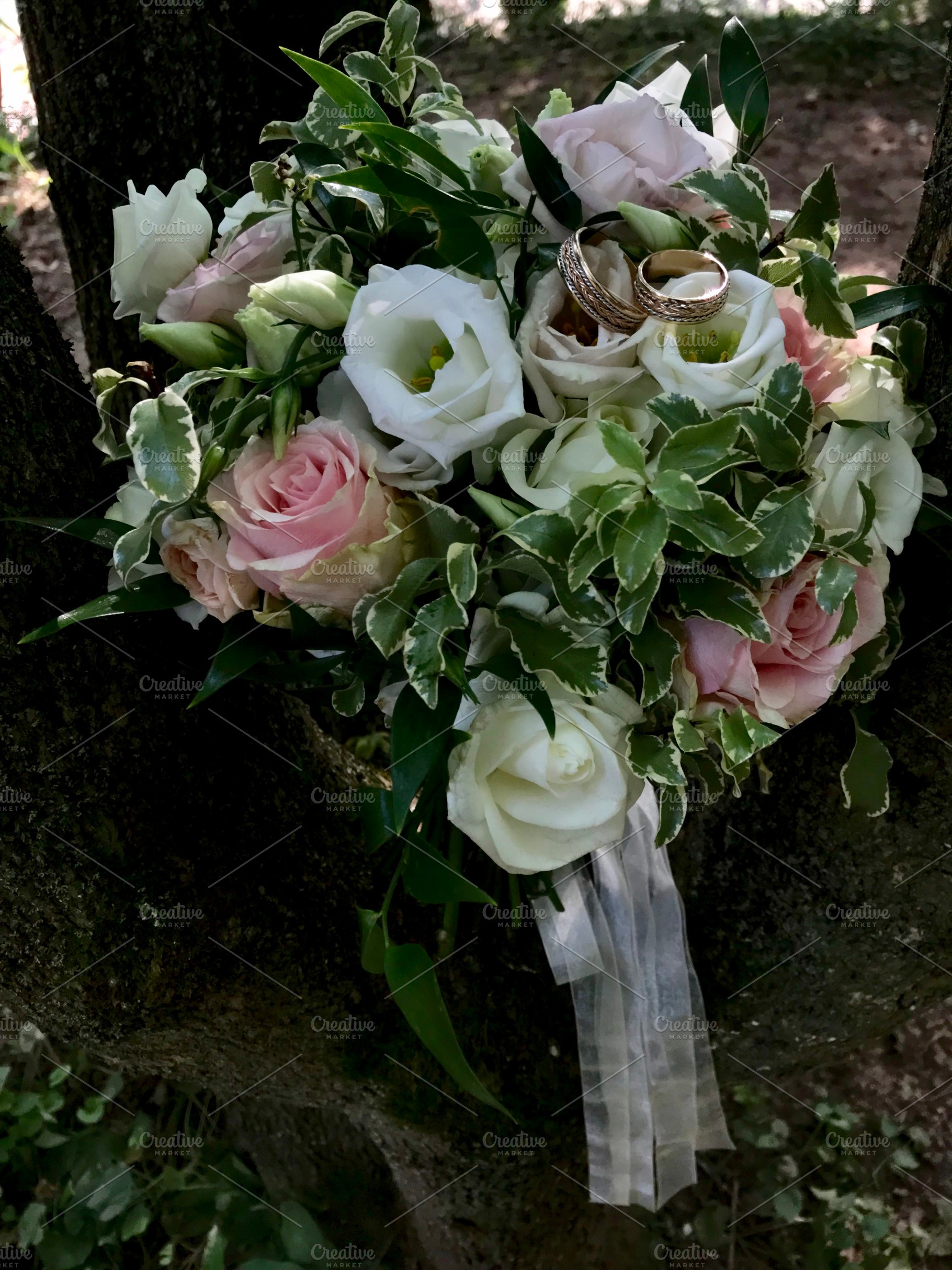 Elegant wedding bouquet with roses and wedding rings outdoors, a Photo by AS photostudio