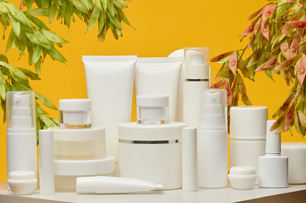 Set of white plastic cosmetic packaging without brand on yellow