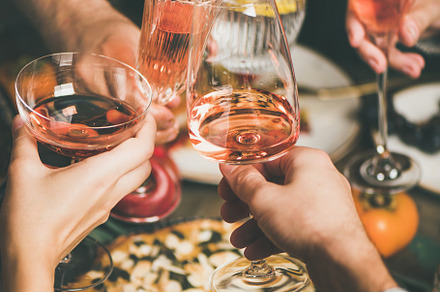 Friends clinking glasses with rose featuring traditional, christmas, and new, a Food & Drink Photo by Foxys