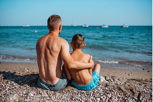 Rear view of son and father looking, a Sports & Recreation Photo by HalfPoint