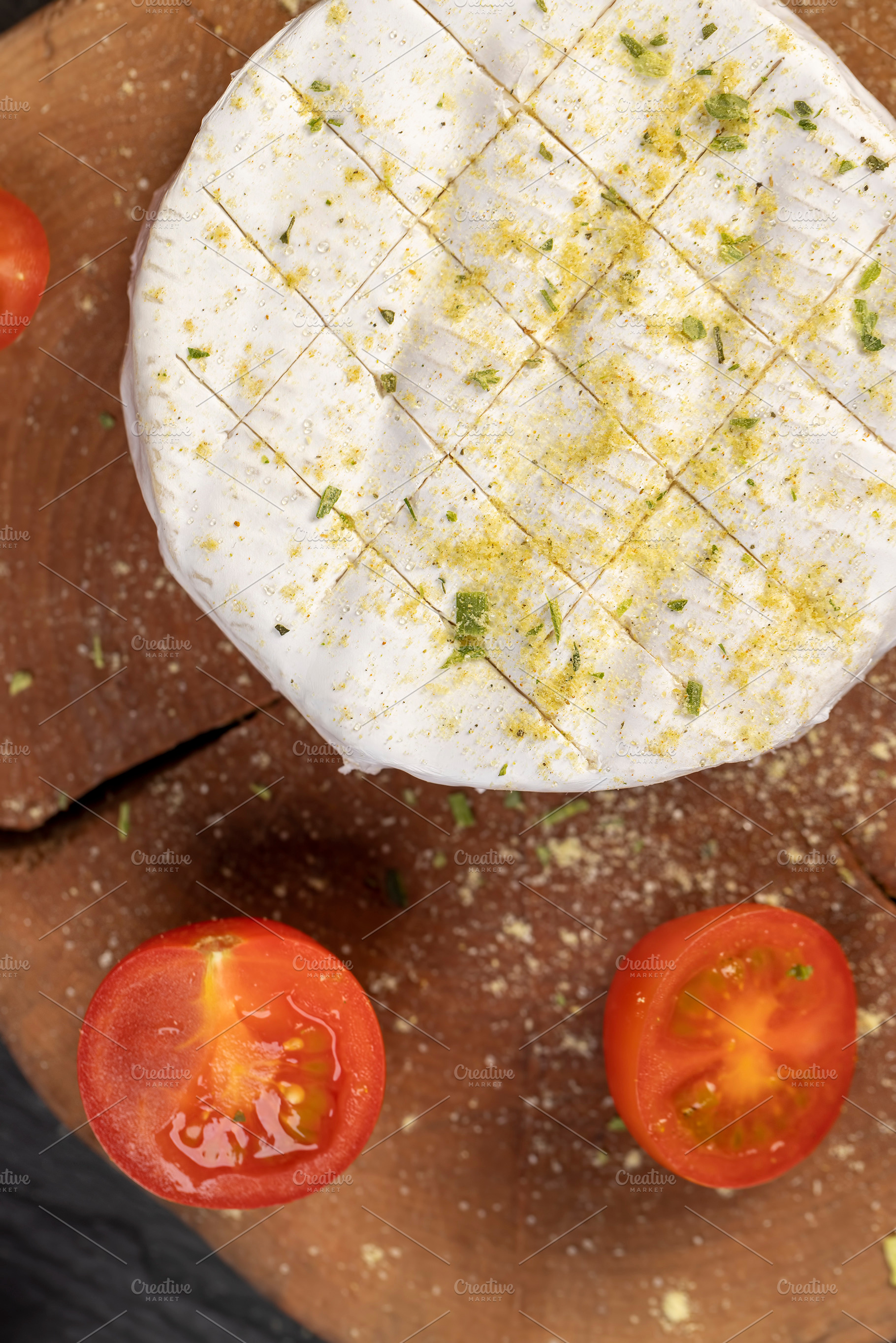 white soft cheese in salt and spices and small red round tomatoes on the table, a Photo by rsoollAI
