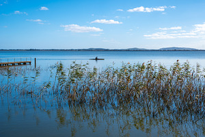 Kayaker paddling near wooden pier on Lake Colac, Victoria, Austr, a Nature Photo by GoodGoods