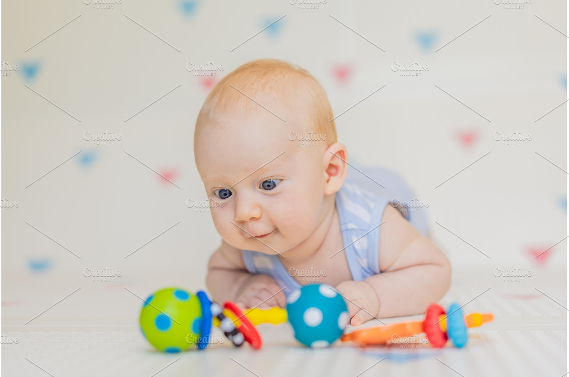 Adorable baby playing with colorful, a Person Photo by Elizaveta Galitskaya