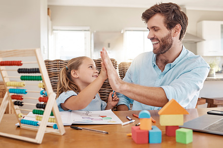 Education, learning and high five by father and girl in homeschooling lesson at kitchen table. Support, teaching and help in child development by parent and daughter winning in homework, abacus math, a Photo by Peopleimages.com