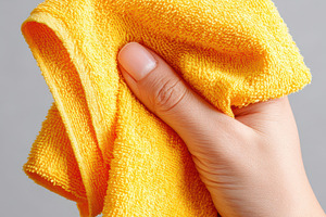 Hand with cleaning microfiber cloths, an Abstract Photo by AlyaAnd