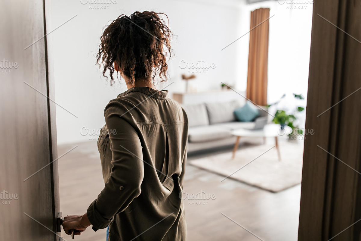 Back View Of African American Lady Opening Door Entering Apartment, a Photo by Prostock-Studio (Photo 1 of 2)