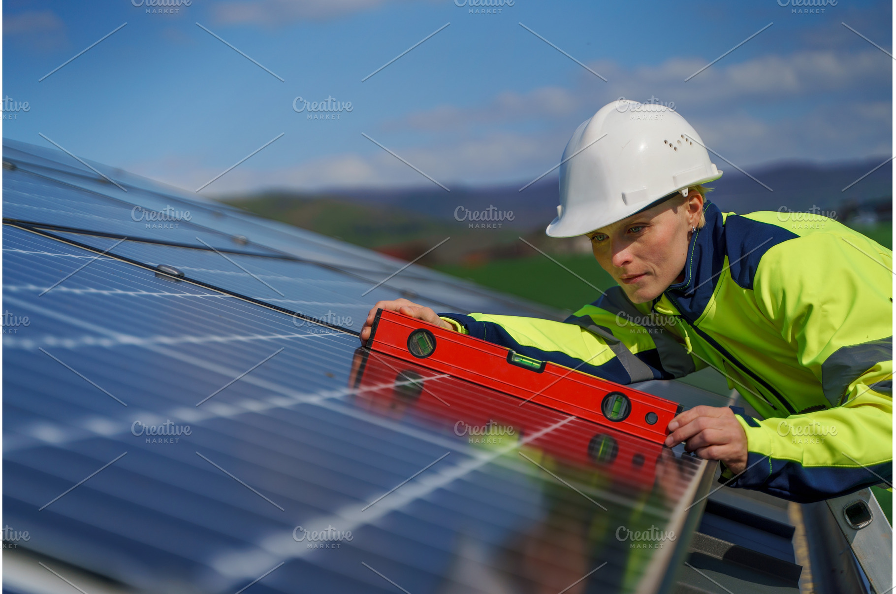 Woman engineer installing a solar, an Industrial Photo by HalfPoint