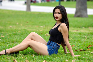 beautiful young woman seated on grass, AI generated, a Photo by WorldOfPhotos