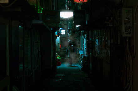 Girl standing in alleyway light