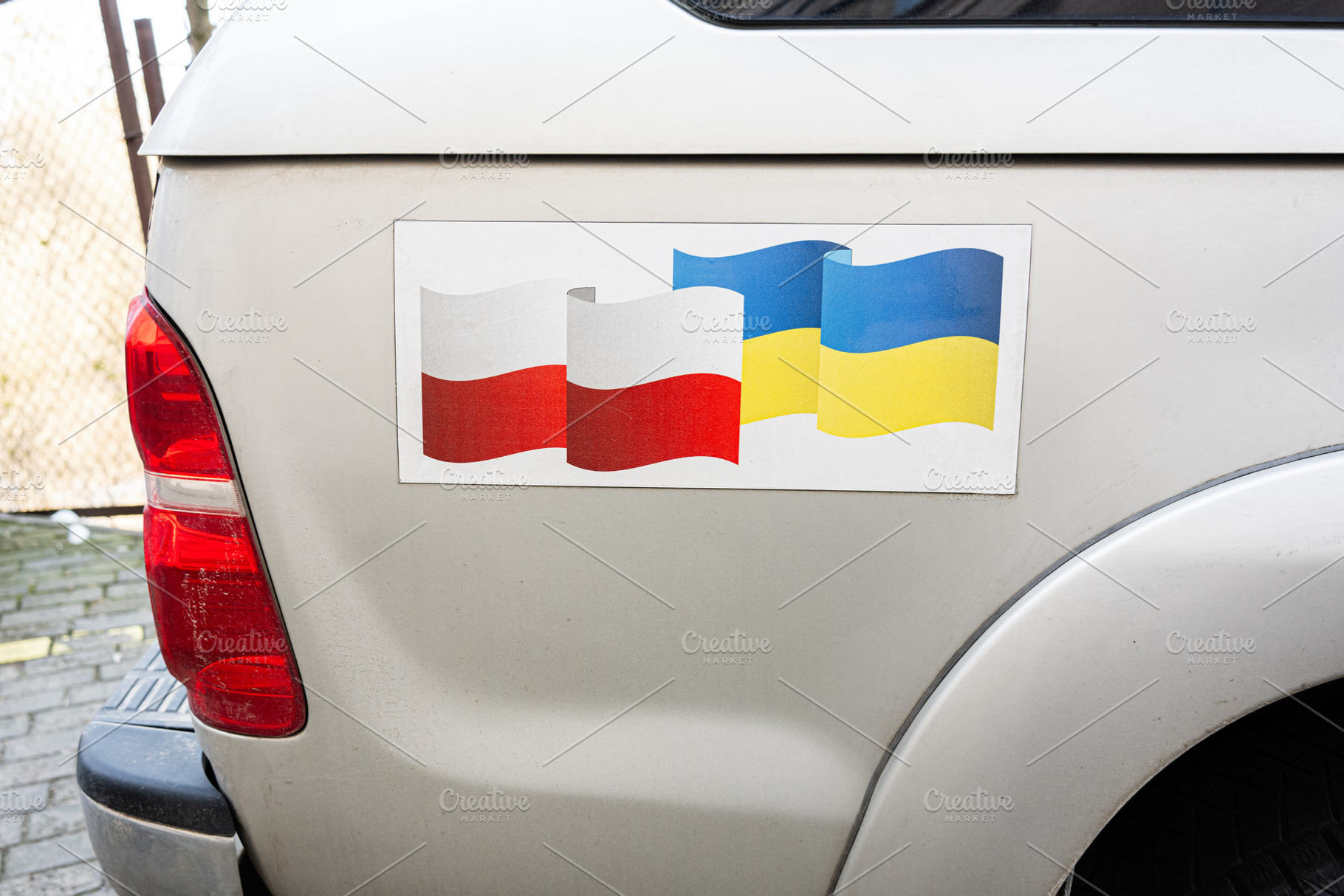 Truck displaying Polish and Ukrainian flags symbolizing connection and friendsh, a Photo by AS photostudio