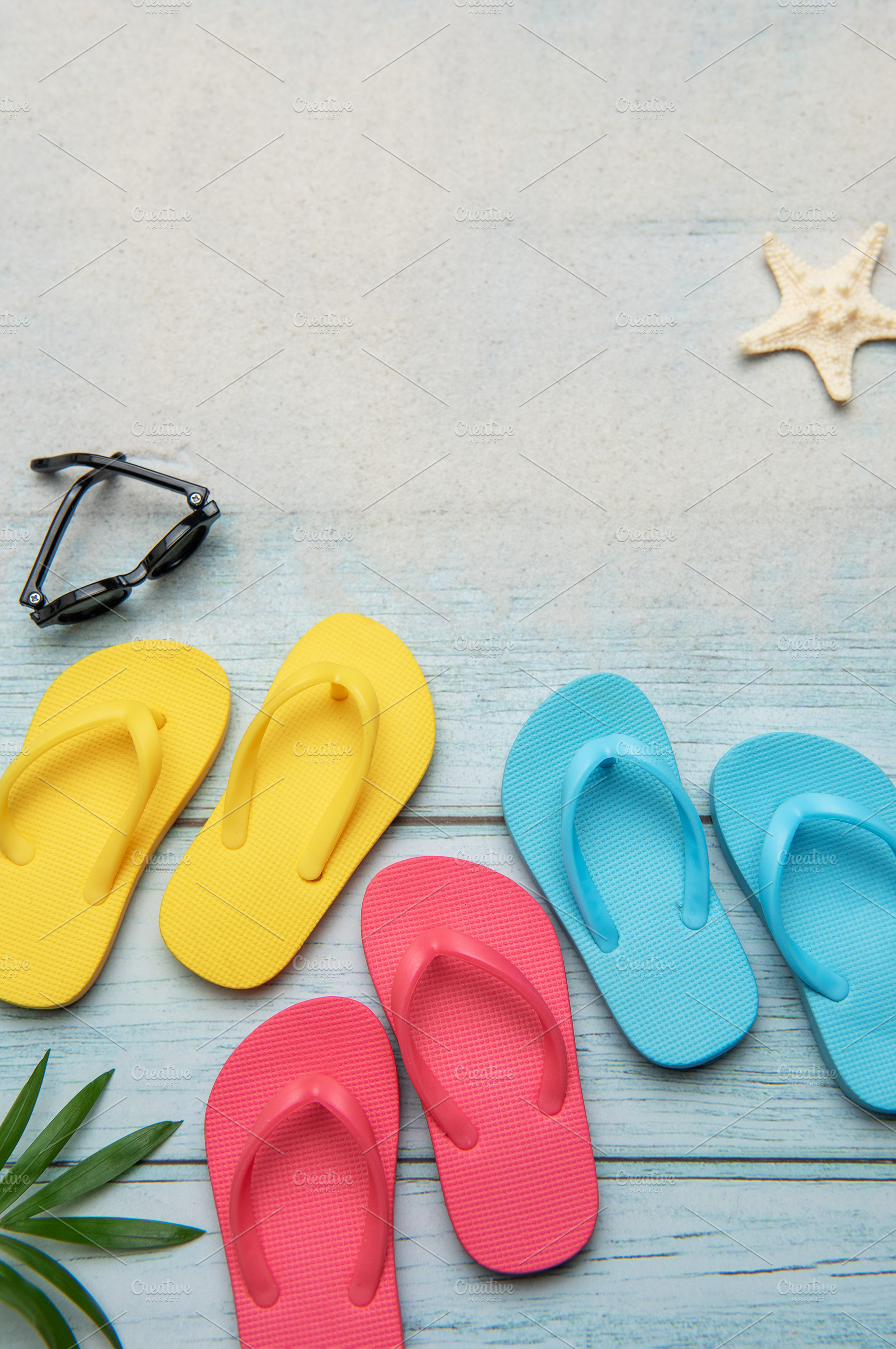 Colorful flip flops and sunglasses resting on beach boardwalk, e, a Holiday Photo by Olena Rudo