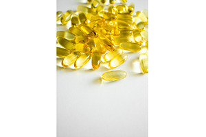 Golden yellow softgel capsules, a Health & Medical Photo by volodymyrshtun13795